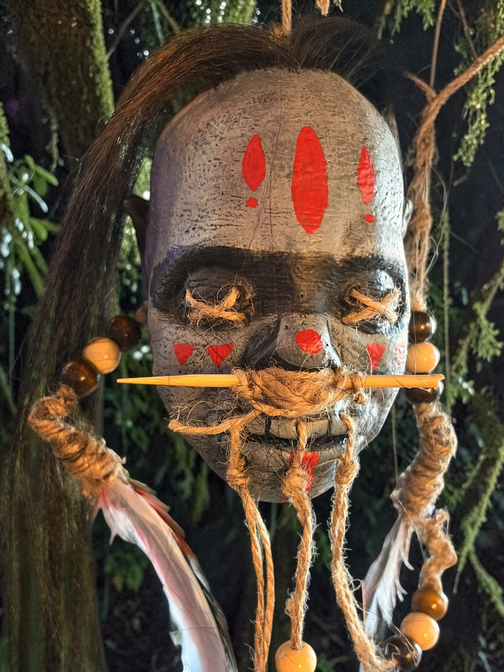 Latex Shrunken Head with Red Feathers