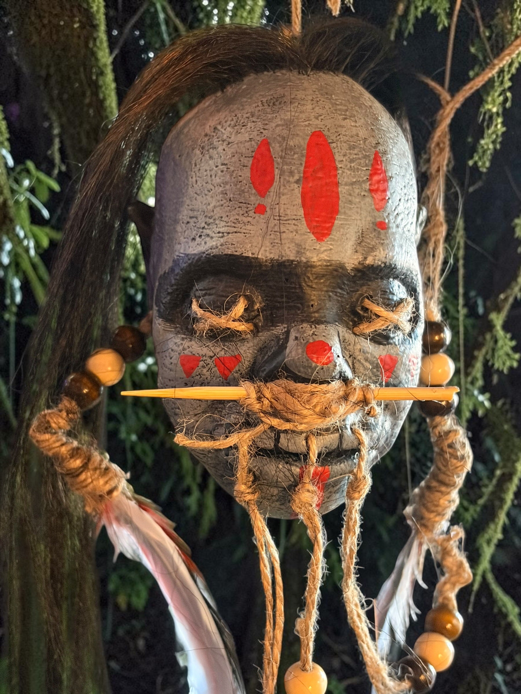 Latex Shrunken Head with Red Feathers