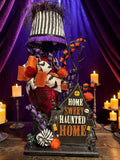 Halloween-Emporium Couture Haunted House Lamp with a black and white striped shade, orange bows, and gothic decor.