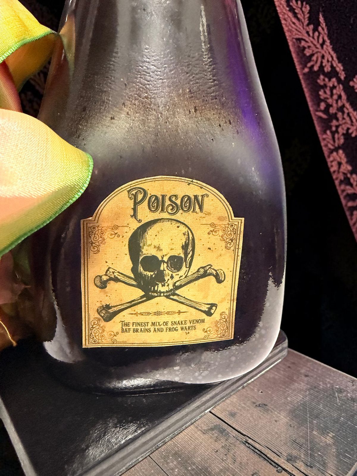 Halloween-Emporium Couture Poison bottle lamp with a vintage skull and crossbones label and rechargeable LED light.