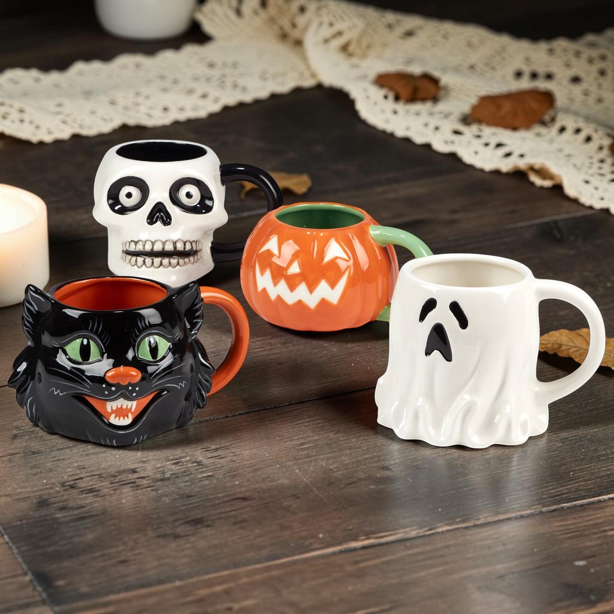 Halloween-Emporium set of four 3-D ceramic Halloween mugs featuring a black cat, white ghost, skull, and pumpkin.