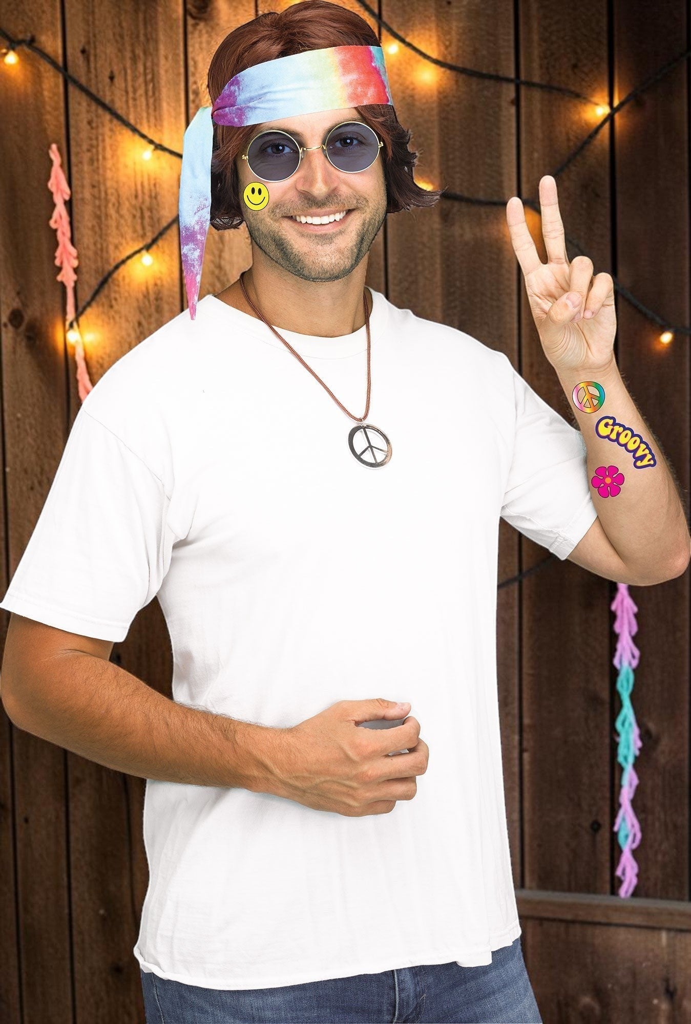 Halloween-Emporium 60s hippie costume kit featuring a tie-dye headscarf, peace sign necklace, fun specs, and tattoos.