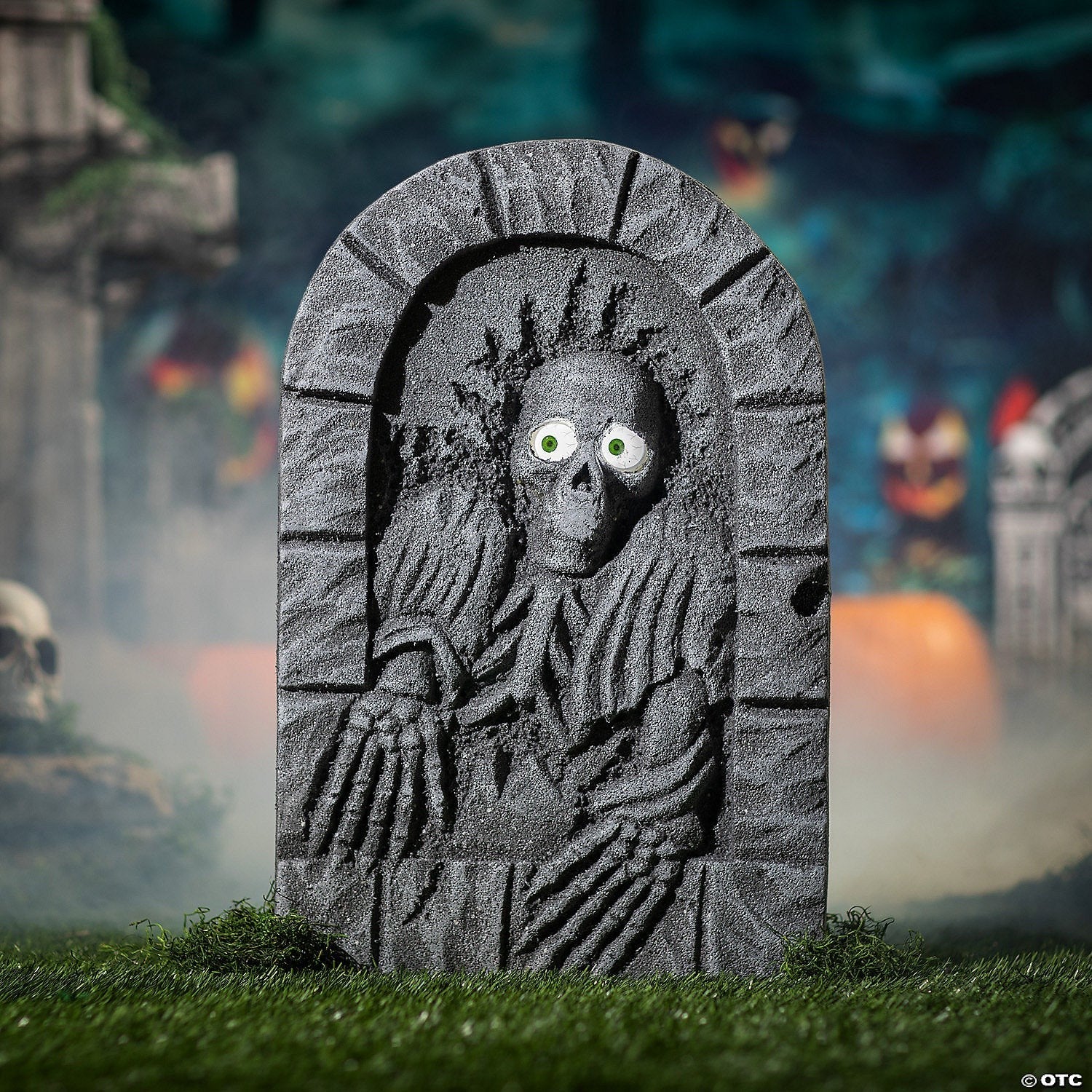 Halloween-Emporium animated tombstone with a skeleton rising from the grave featuring glowing green eyes