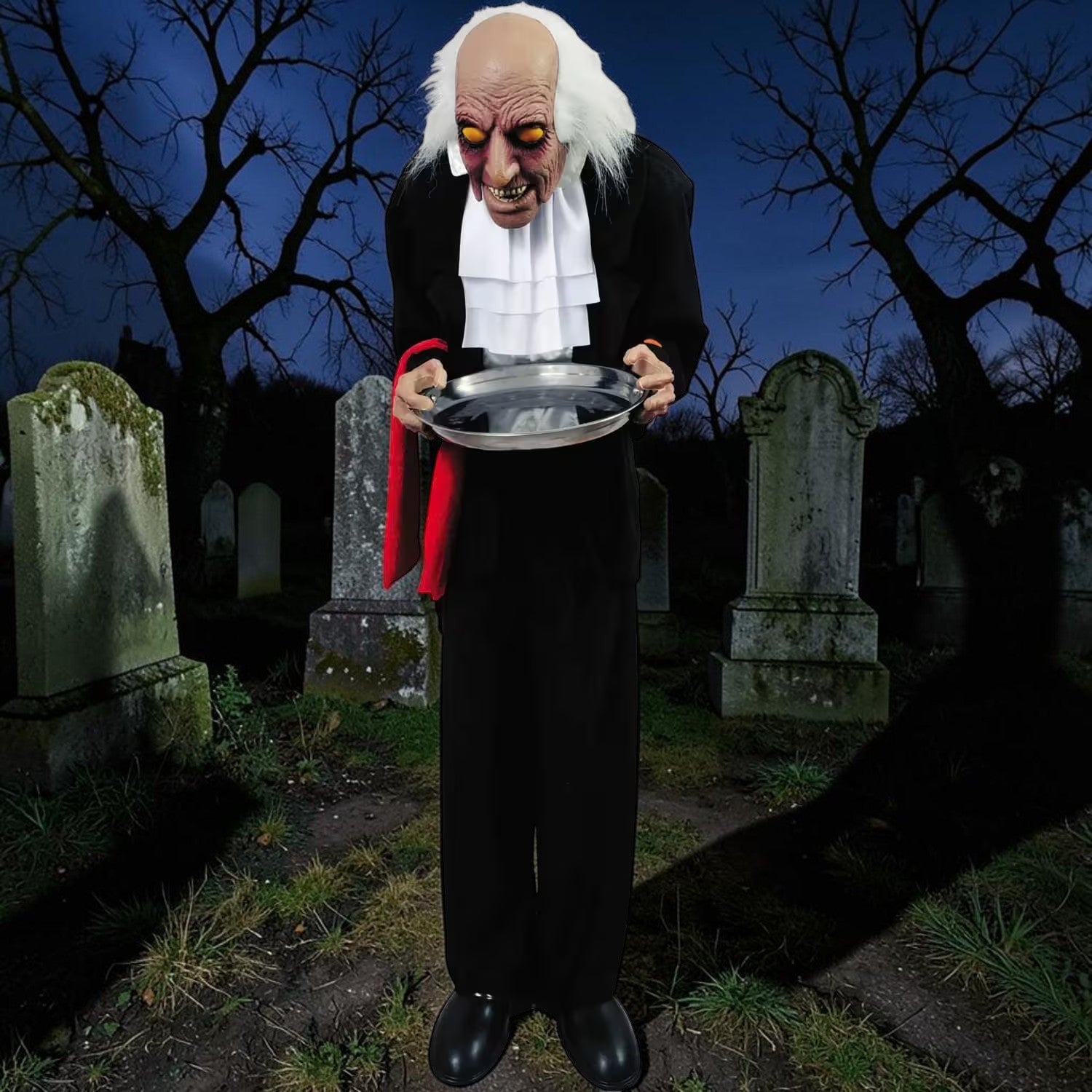Halloween-Emporium 4-foot Ben the Butler animatronic with glowing eyes, black suit, and serving tray in a graveyard.