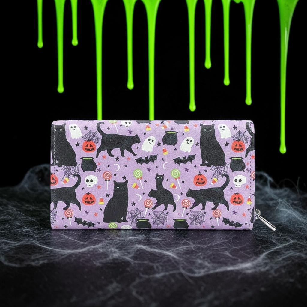 Halloween-Emporium vinyl wallet featuring a purple collage of black cats, ghosts, pumpkins, and candy for Halloween.