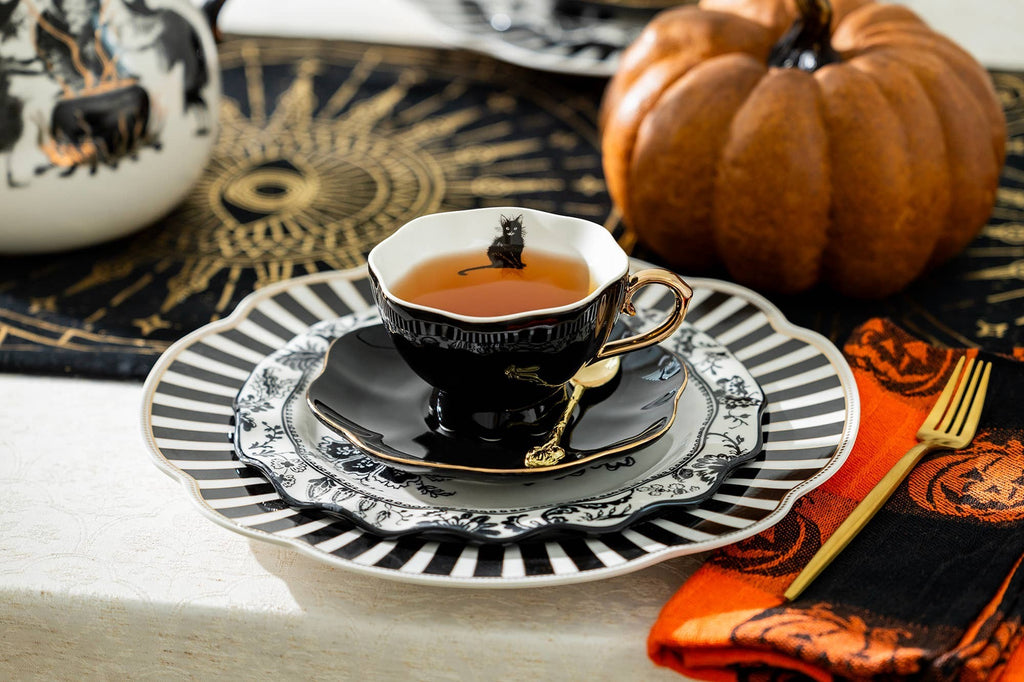 Halloween-Emporium black and white porcelain tea cup and saucer set with gold trim and a black cat silhouette design.