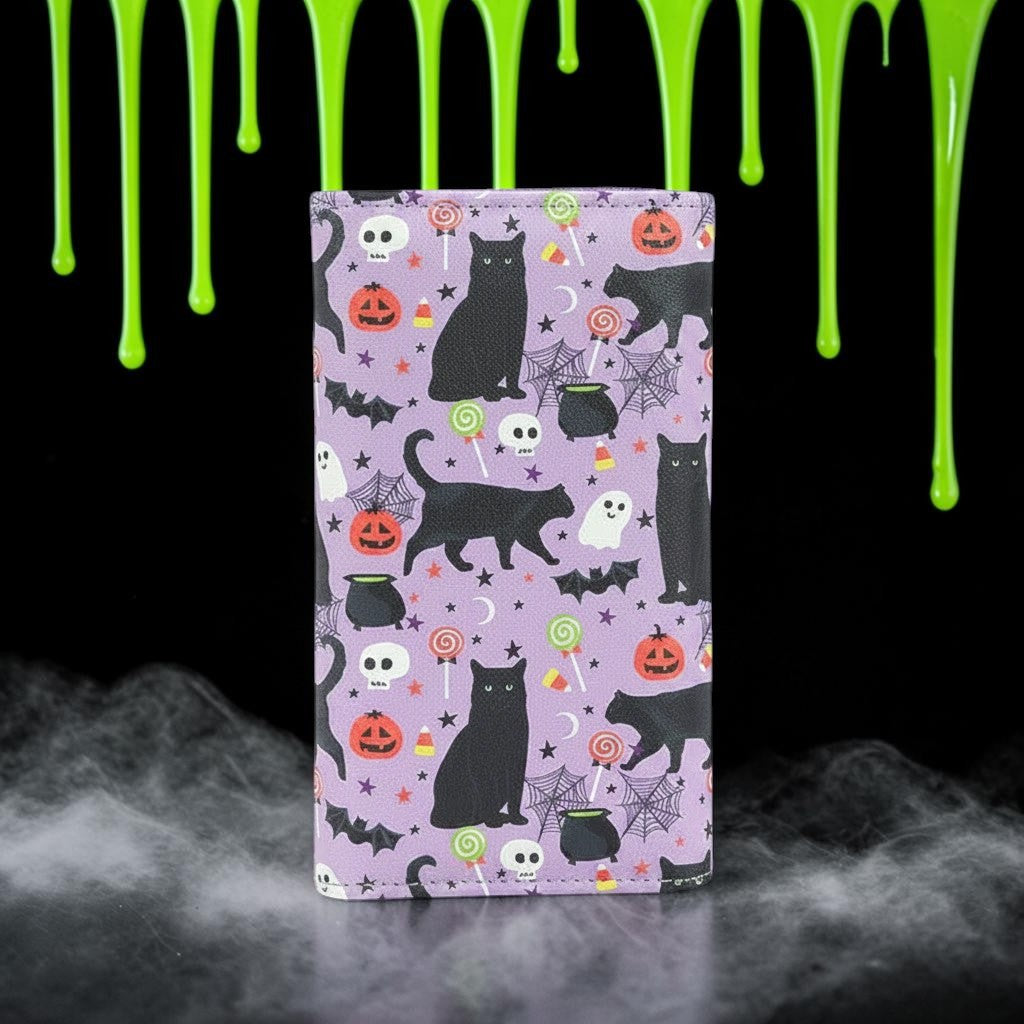 Halloween-Emporium vinyl wallet featuring a purple background with a black cat, pumpkin, and candy collage print.