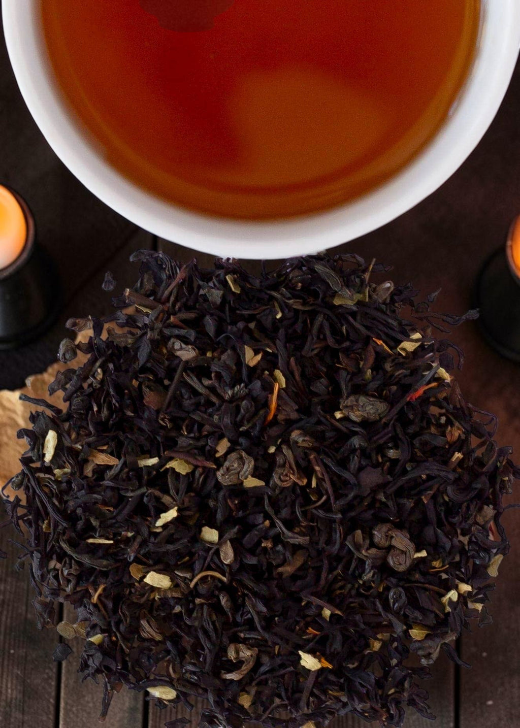 Halloween-Emporium Black Pearl Rum Smoke black tea blend with gunpowder pellets and coconut pieces near a tea cup.