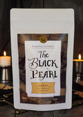 Halloween-Emporium The Black Pearl rum and smoke flavored black tea in a white stand-up pouch with pirate branding.