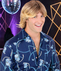 Halloween-Emporium blonde 70s feathered wig worn by a man in a vintage floral shirt at a disco-themed party