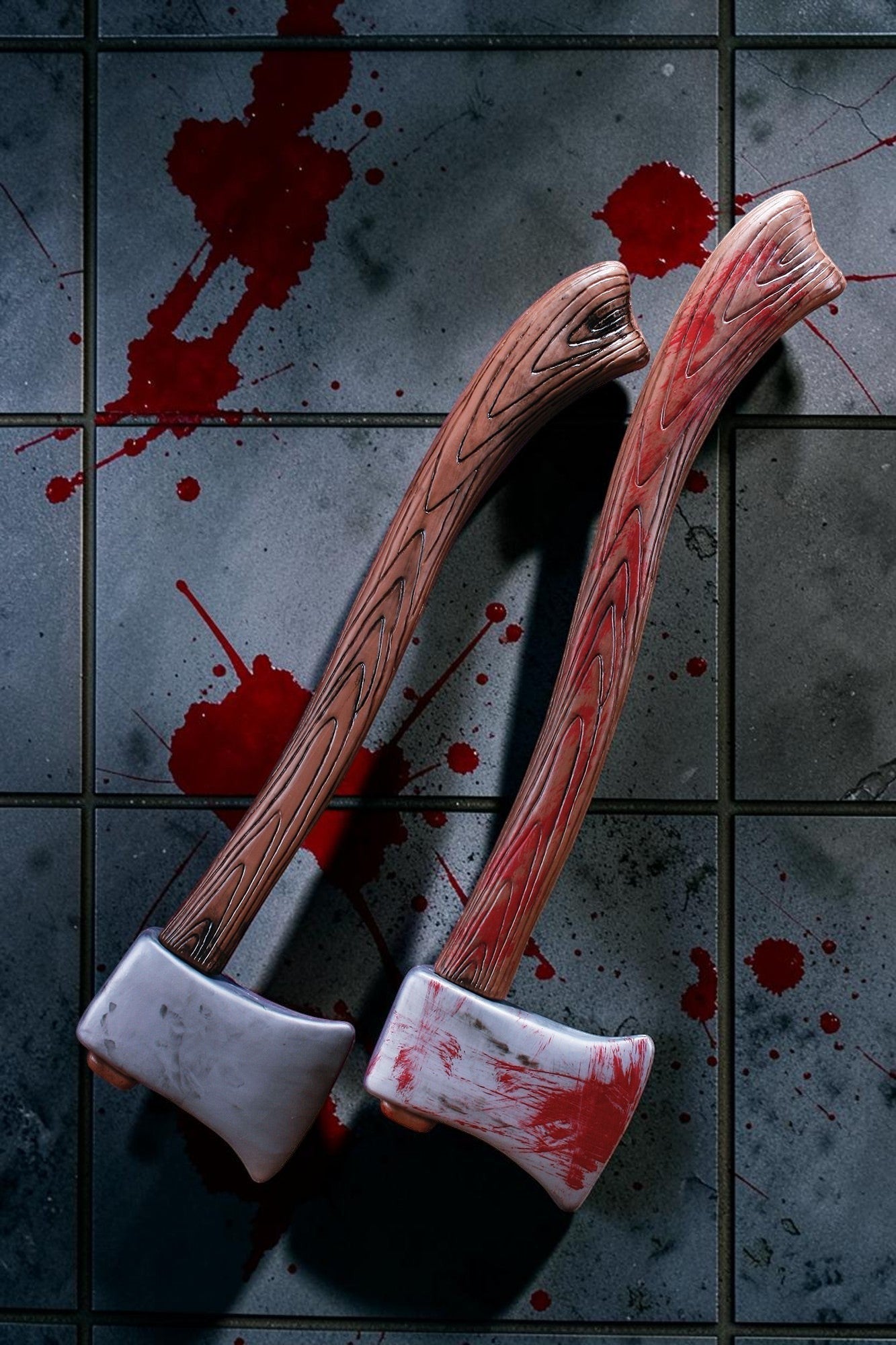 Halloween-Emporium plastic axe props with wood-grain handles and blood-splattered metallic blades on a tiled floor.