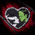 Halloween-Emporium Bride and Frankenstein heart-shaped embroidered patch with barbed wire border on red velvet