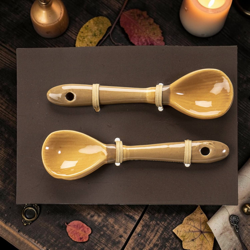 Halloween-Emporium set of two glossy tan ceramic tea spoons shaped like whimsical witch broomsticks