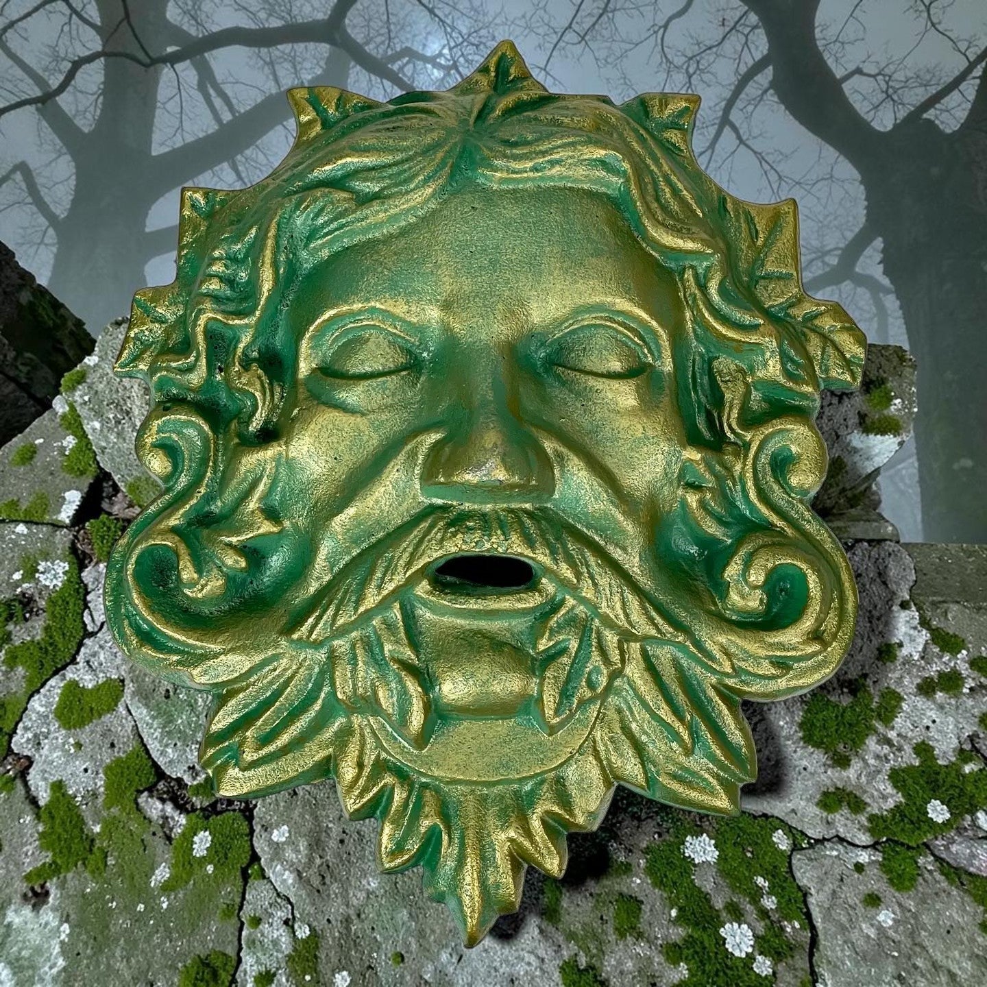 Halloween-Emporium cast iron Green Man wall plaque with verdigris green and antique gold foliage and bearded face detail.