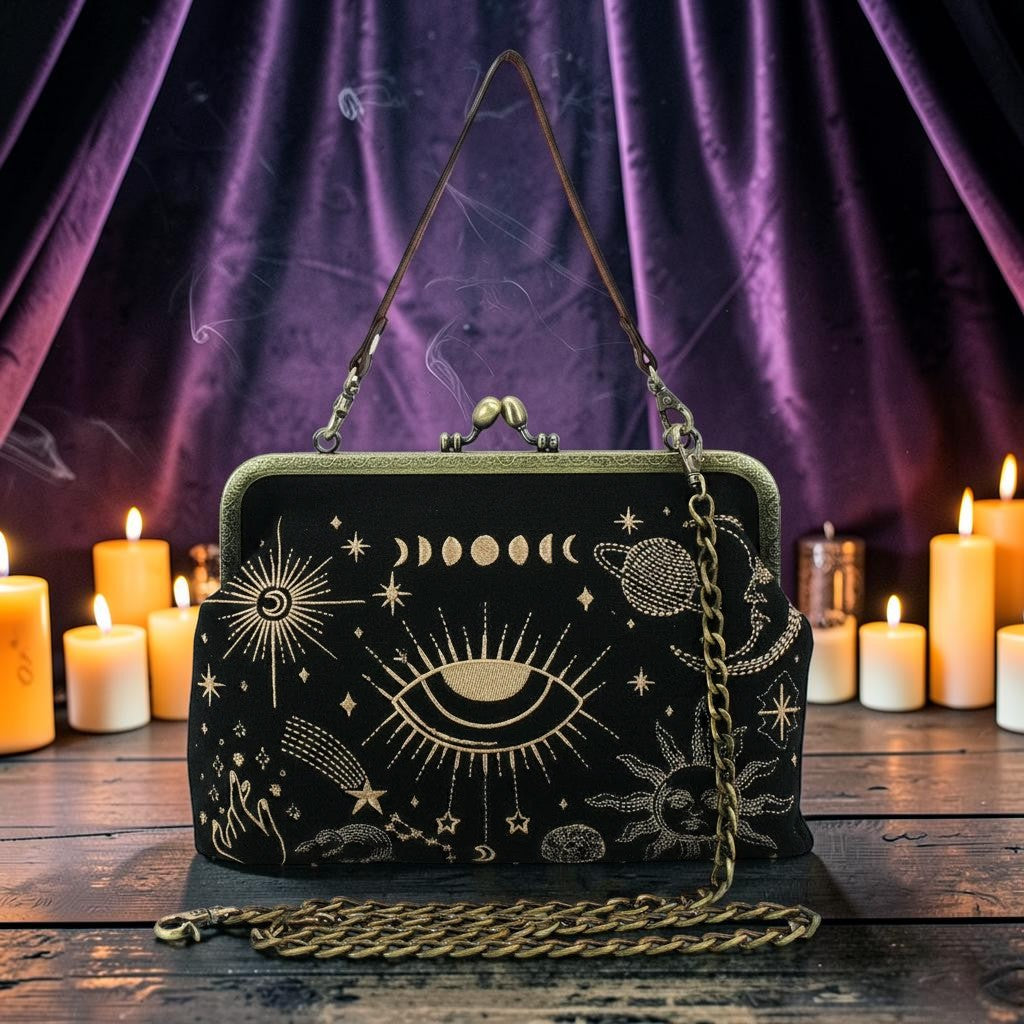Halloween-Emporium black kisslock handbag with gold celestial embroidery, featuring moon phases and mystical symbols.