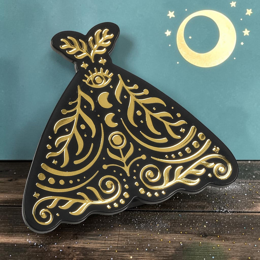 Halloween-Emporium Pantry Moths bag clip featuring a black moth shape with intricate gold celestial foil detailing.