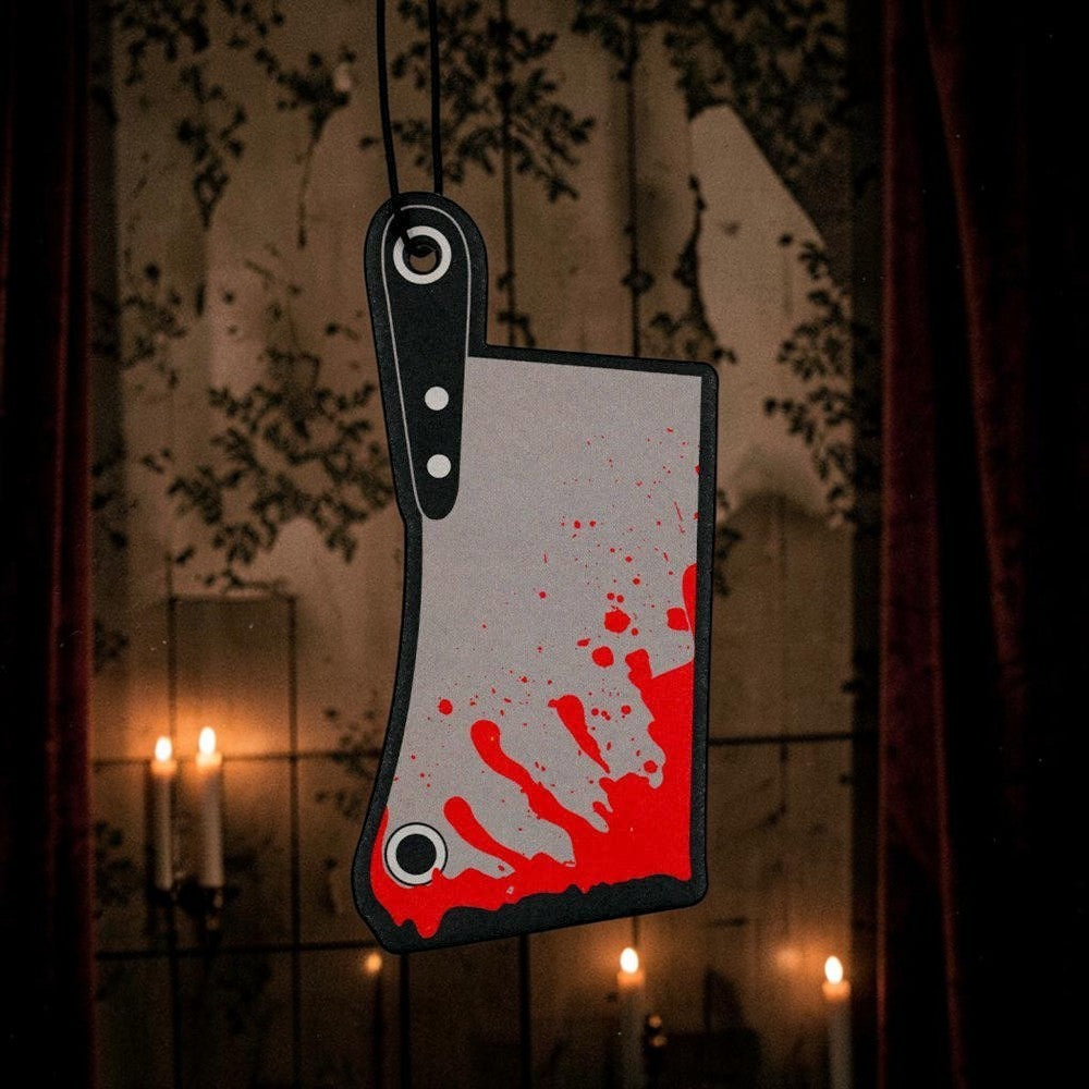 Halloween-Emporium cleaver-shaped car air freshener with realistic blood splatter design hanging against a dark background.