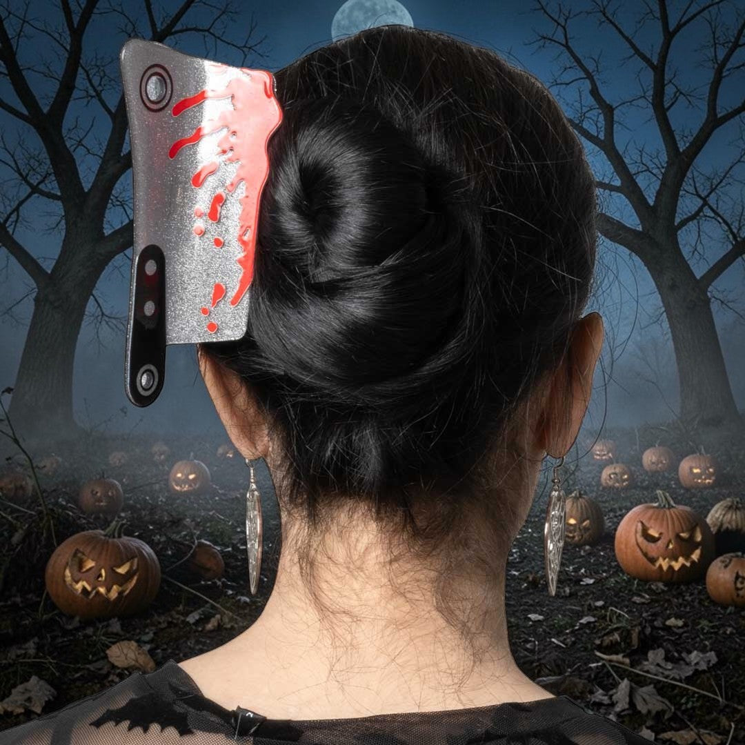 Halloween-Emporium silver glitter cleaver claw clip with red blood splatter worn in a dark hair bun
