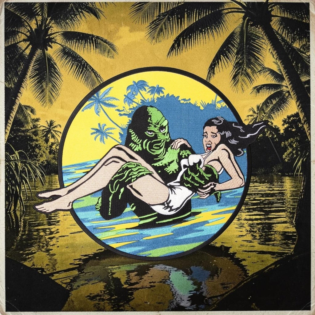 Halloween-Emporium Creature from the Black Lagoon embroidered patch featuring the monster carrying a woman.