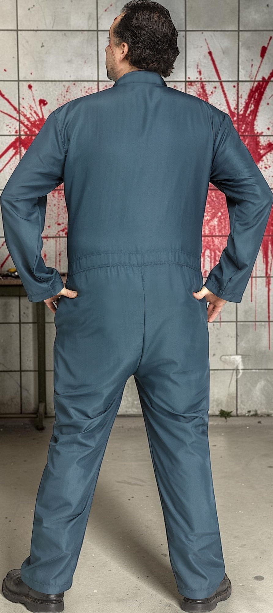 Halloween-Emporium dark blue mechanic coveralls worn by a man standing against a blood-splattered tiled wall