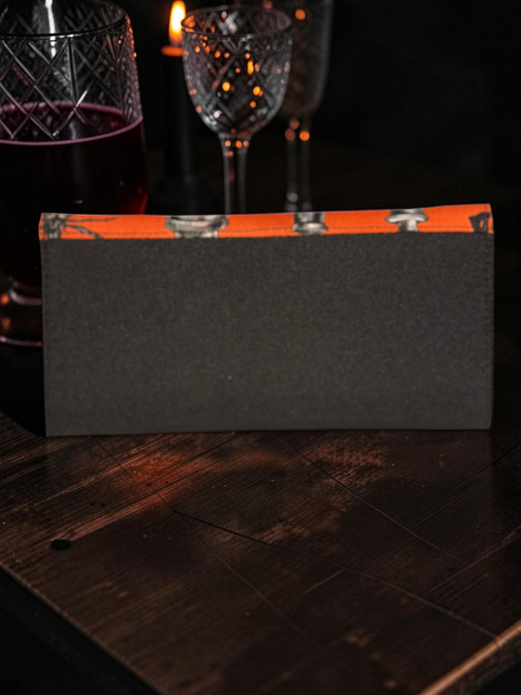 Halloween-Emporium Deadly Apothecary clutch wallet in black with an orange top trim featuring gothic mushroom motifs.