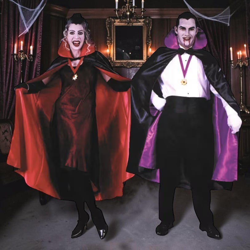 Halloween-Emporium deluxe red and black capes with high collars worn by a vampire couple in a gothic setting