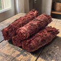 Halloween-Emporium Dragon Blood sage smudge sticks with deep red leaves tied with twine on a rustic wooden table