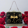 Halloween-Emporium black linen cotton kiss lock bag with gold embroidered dragon and celestial motifs among red roses.