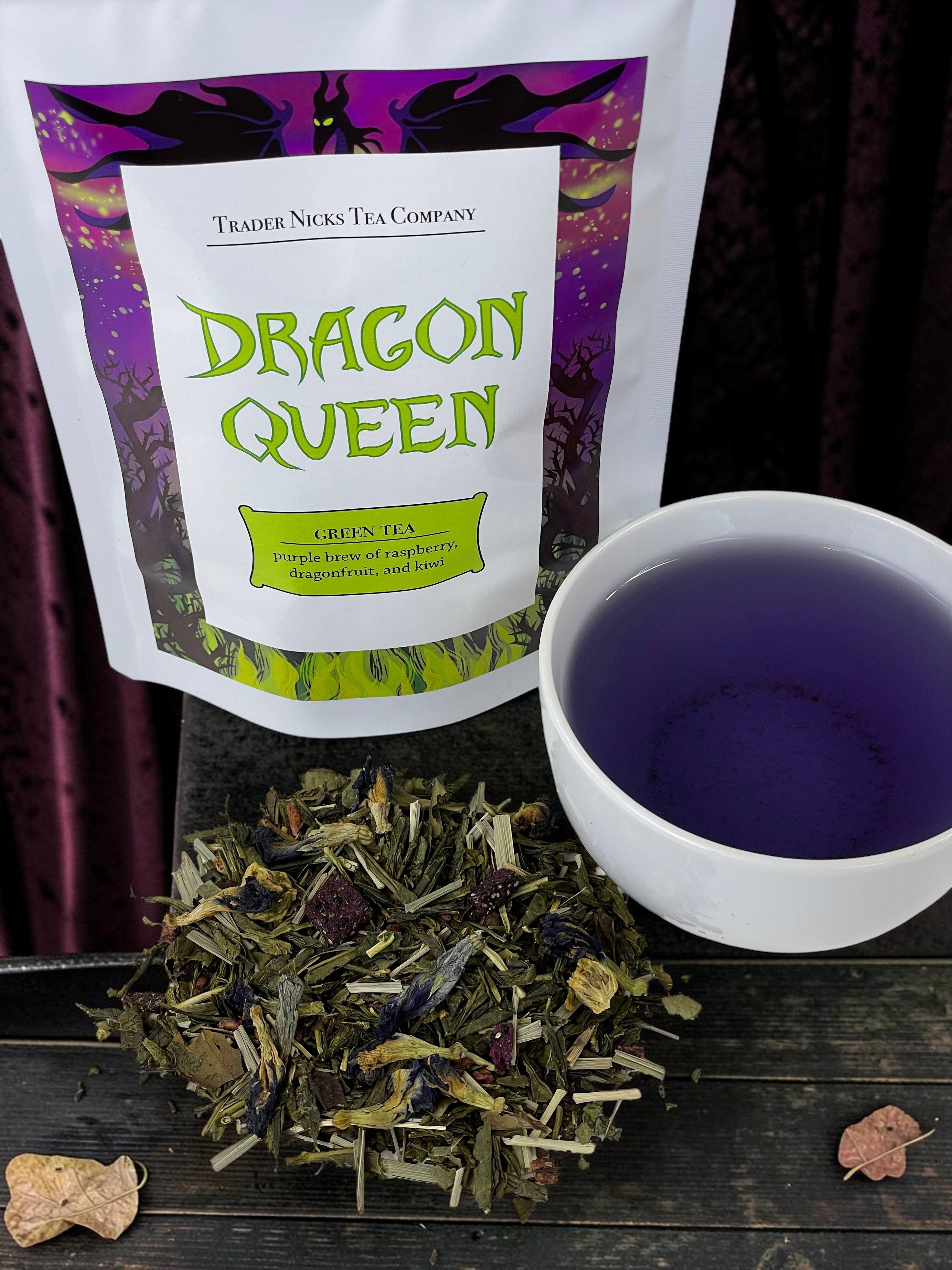Halloween-Emporium Dragon Queen green tea blend with dried fruit and butterfly pea blossoms next to a purple brew.