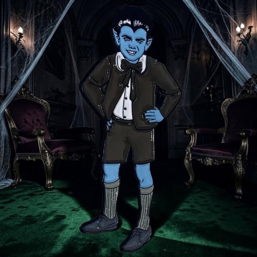 Halloween-Emporium Eddie Munster enamel pin featuring the iconic character in his signature suit against a spooky room.