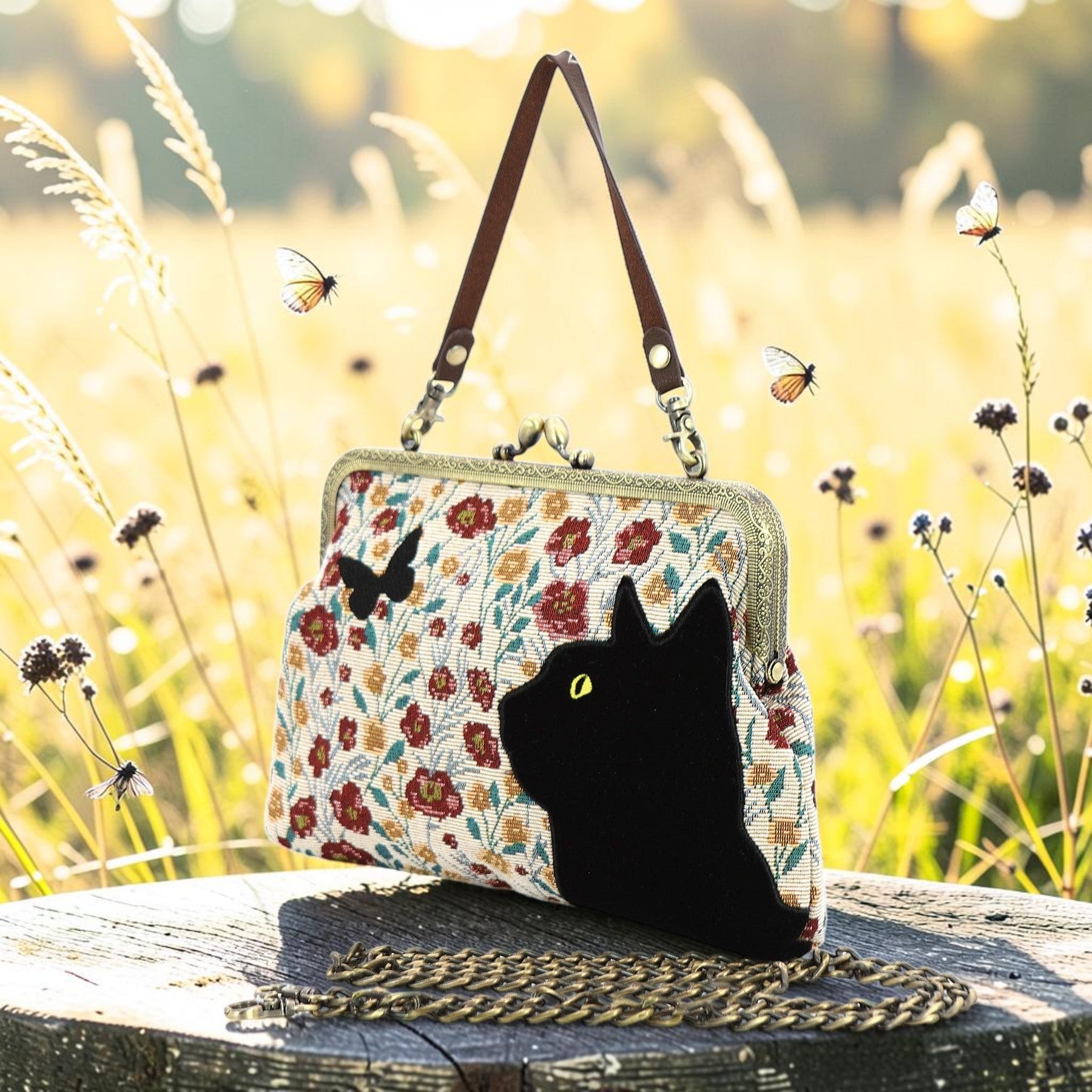 Halloween-Emporium floral kisslock bag featuring a velvet black cat and butterfly appliqué in a sunny meadow setting