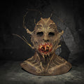 Halloween-Emporium twisted forest creature mask with bark texture, protruding branches, and a bloody, toothy maw.