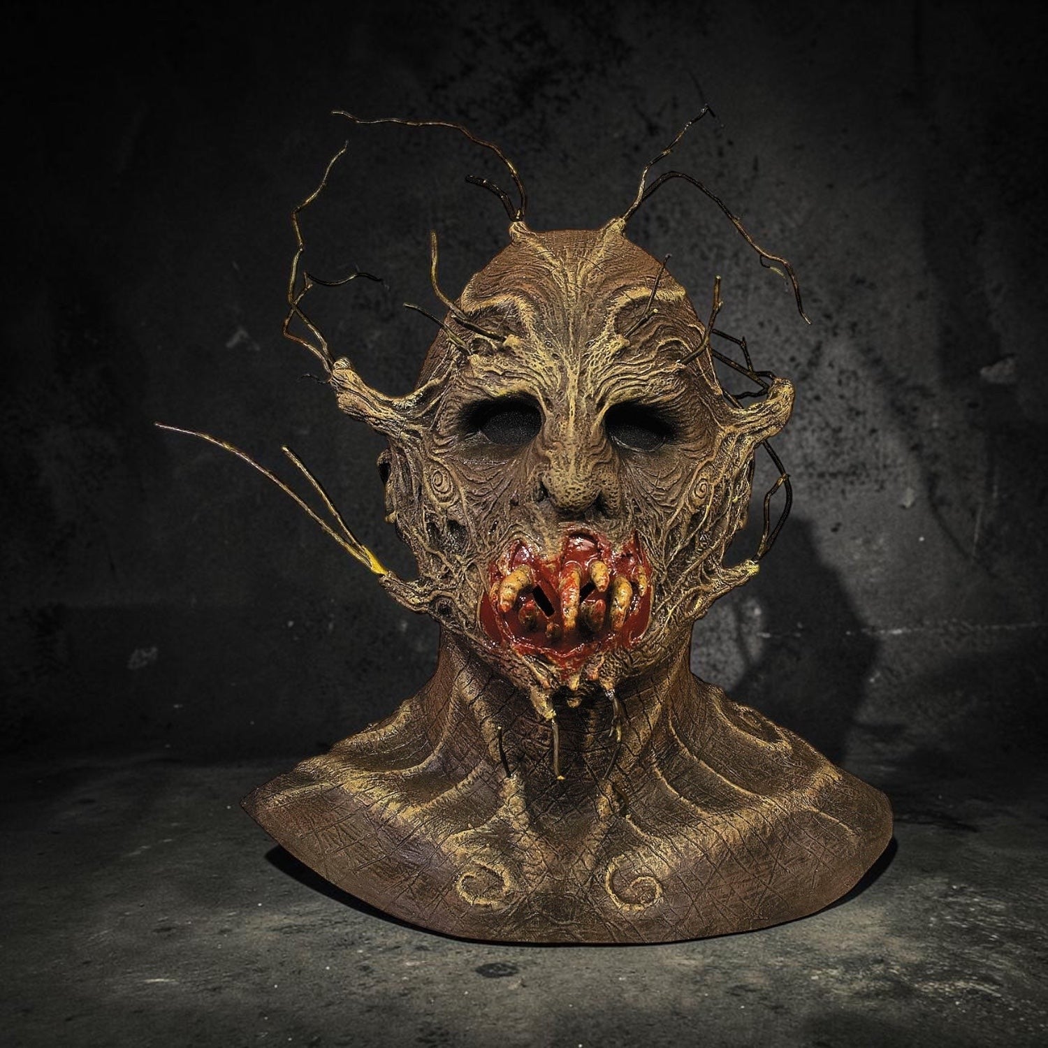 Halloween-Emporium twisted forest creature mask with bark texture, protruding branches, and a bloody, toothy maw.