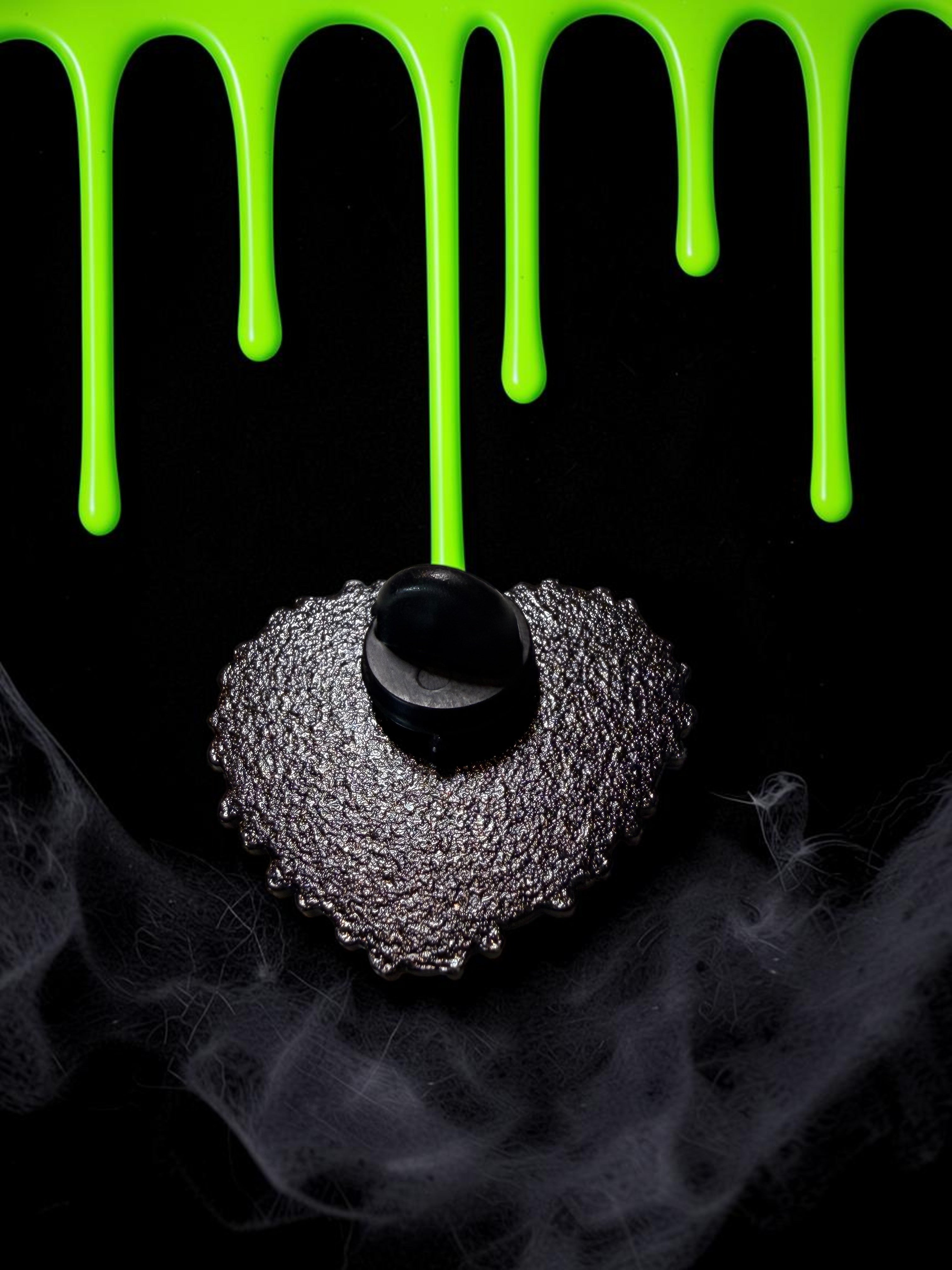 Halloween-Emporium Frankenstein and Bride heart enamel pin back view with black metal texture on a spooky background