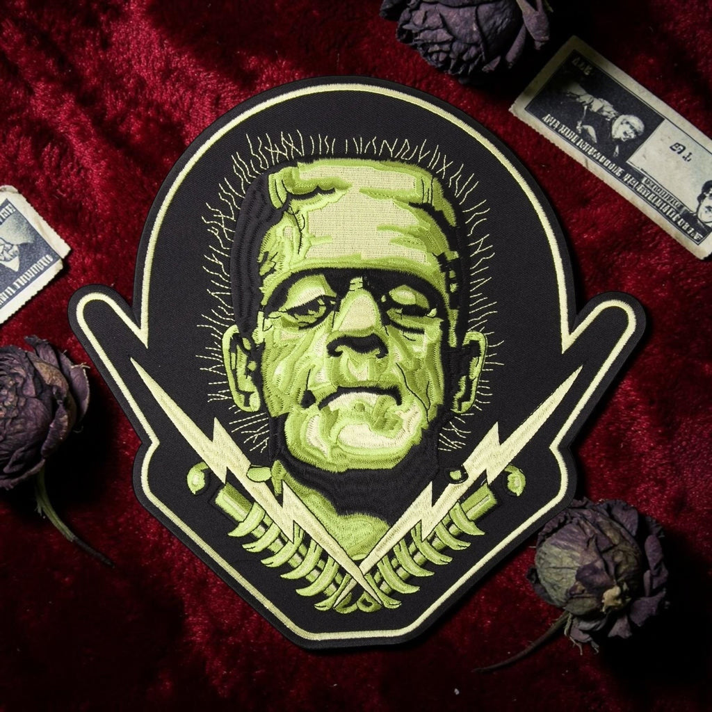 Halloween-Emporium large Frankenstein embroidered iron-on patch with green monster face and lightning bolt details.