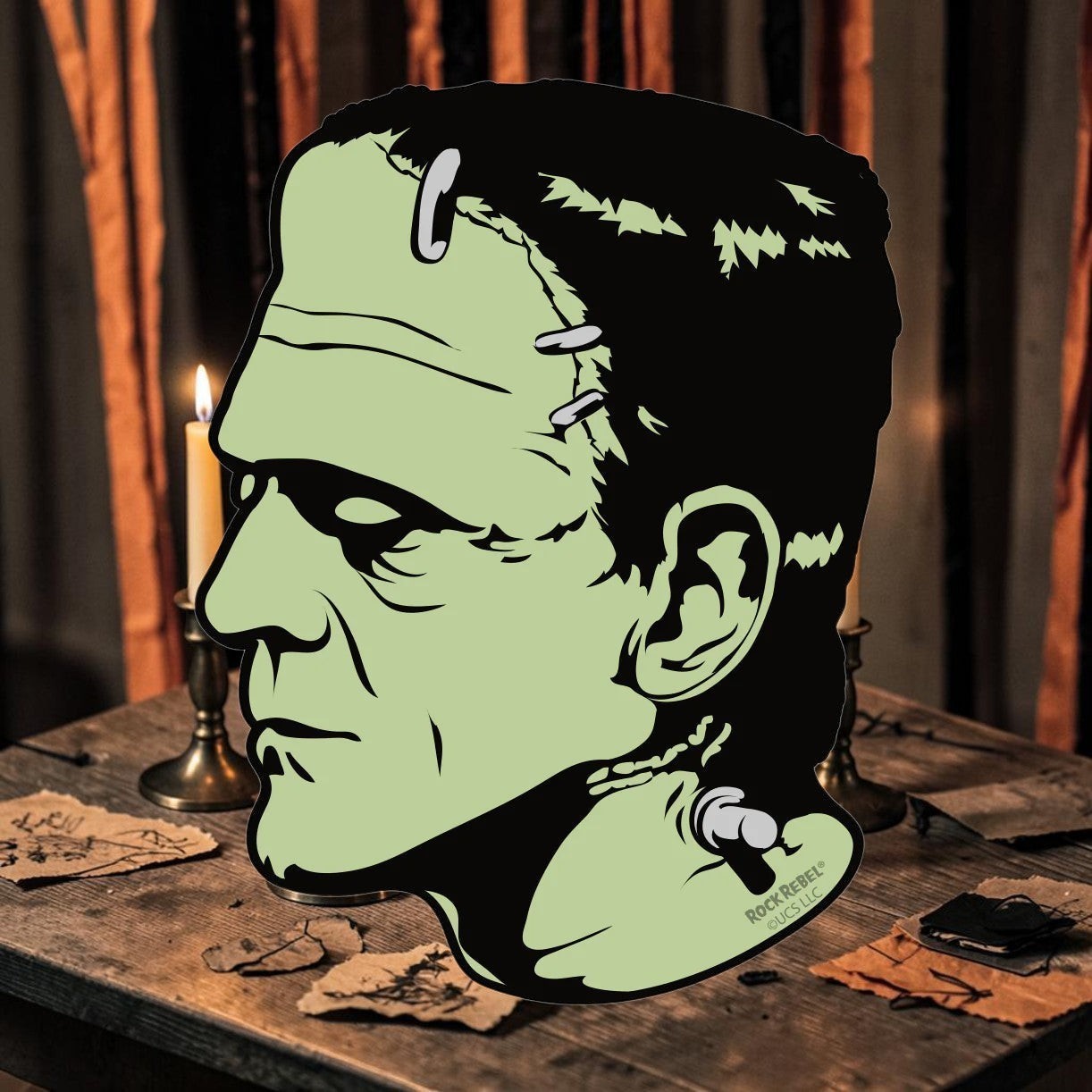 Halloween-Emporium 4-inch Frankenstein vinyl sticker featuring a green profile illustration on a rustic table.