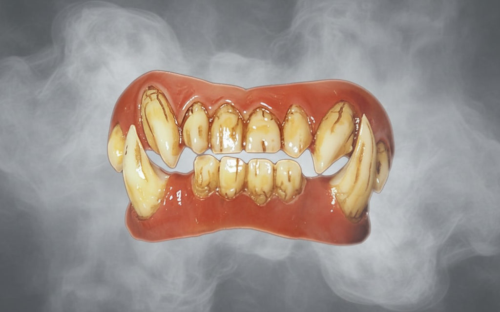 Halloween-Emporium FX Fangs featuring realistic stained veneer teeth with sharp fangs in a smoky grey background.
