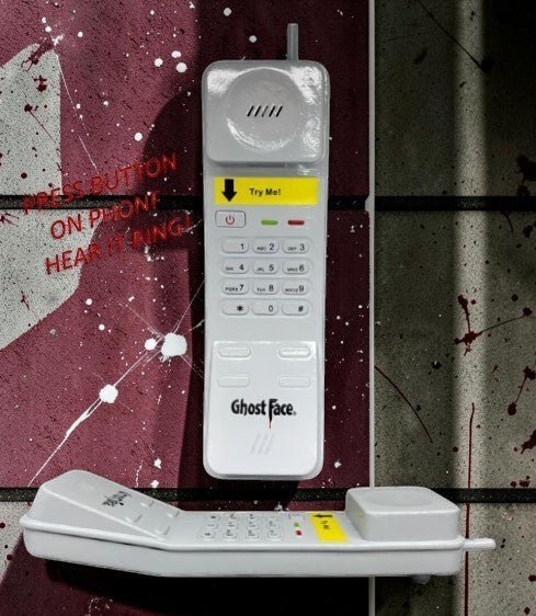 Halloween-Emporium Ghost Face phone prop in white plastic with keypad and interactive ringing sound effect.