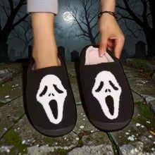 Halloween-Emporium plush house slippers featuring a white Ghost Face mask design on a black background