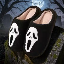 Halloween-Emporium black plush Ghost Face slippers with fuzzy interior lining for cozy horror movie nights