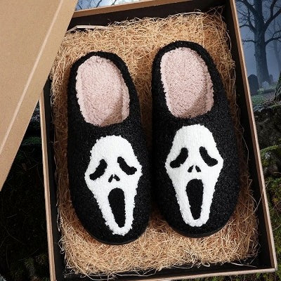 Halloween-Emporium black plush Ghost Face house slippers with white mask design and fuzzy interior lining in a gift box
