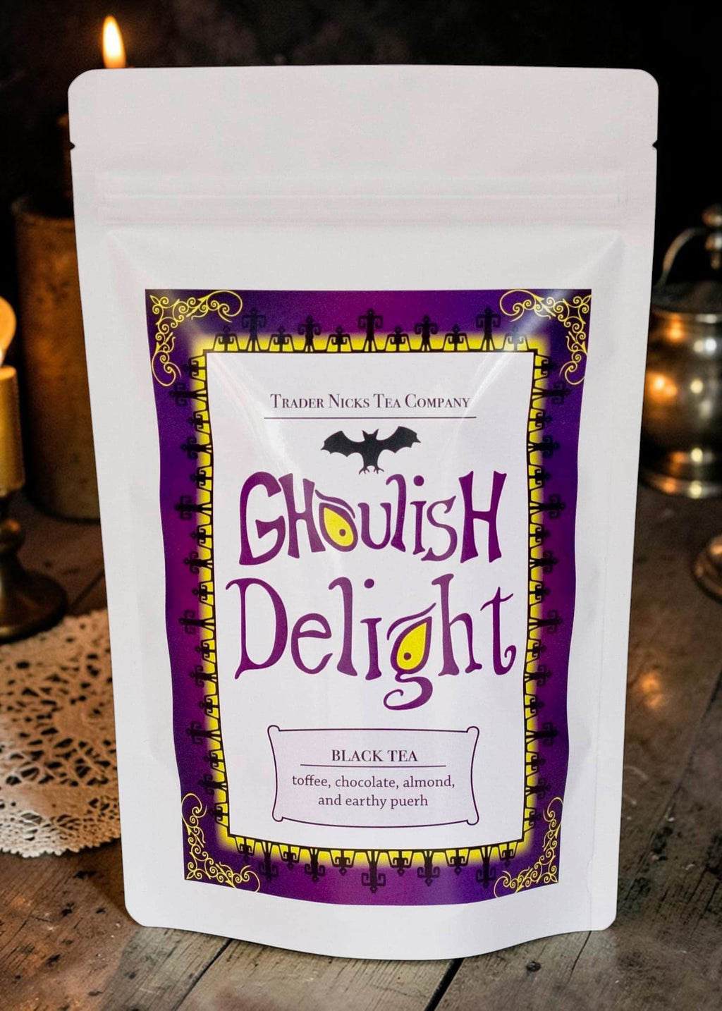 Halloween-Emporium Ghoulish Delight black tea pouch with purple and yellow gothic label featuring a bat illustration.
