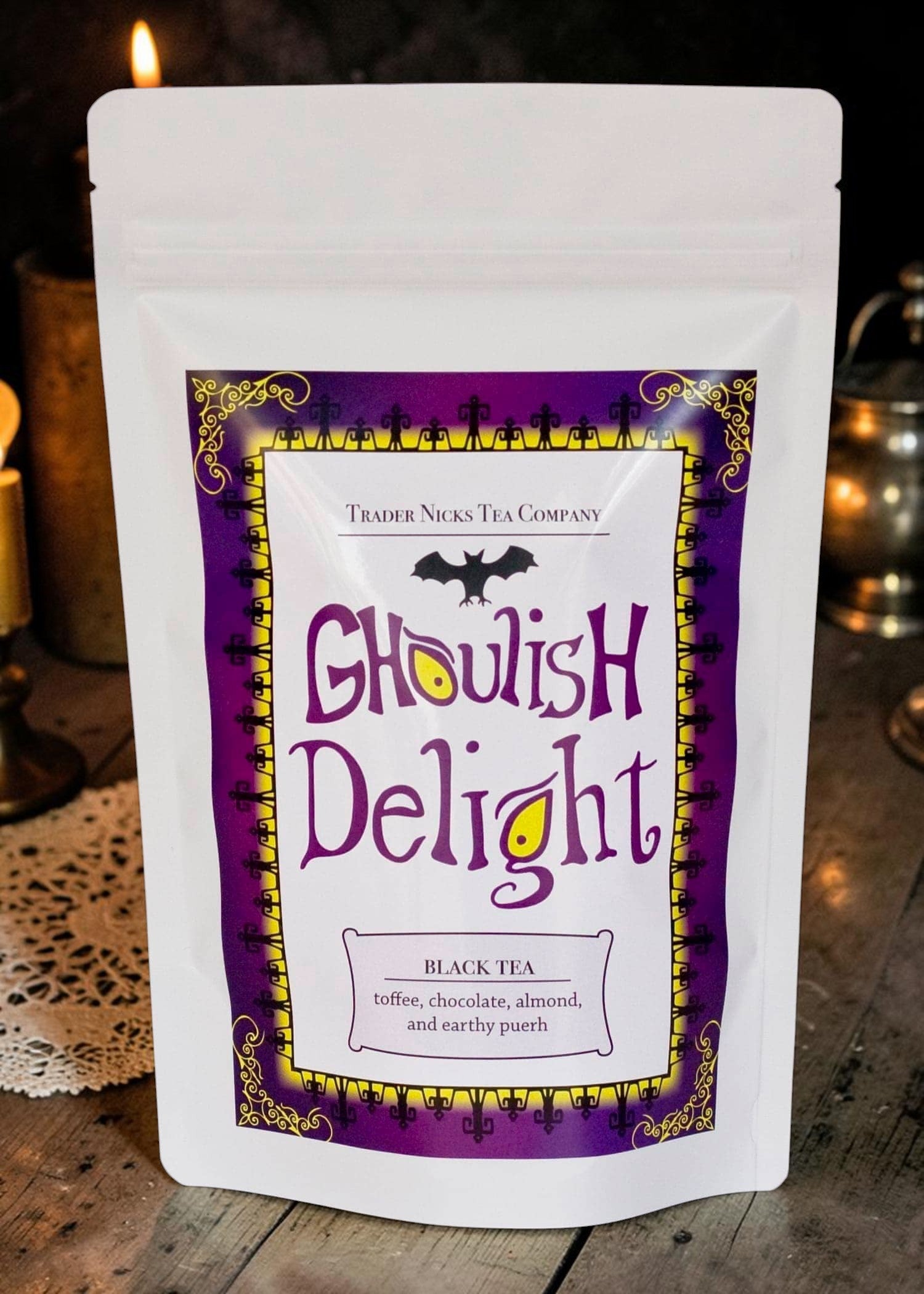 Halloween-Emporium Ghoulish Delight black tea pouch with purple and yellow gothic label featuring a bat illustration.