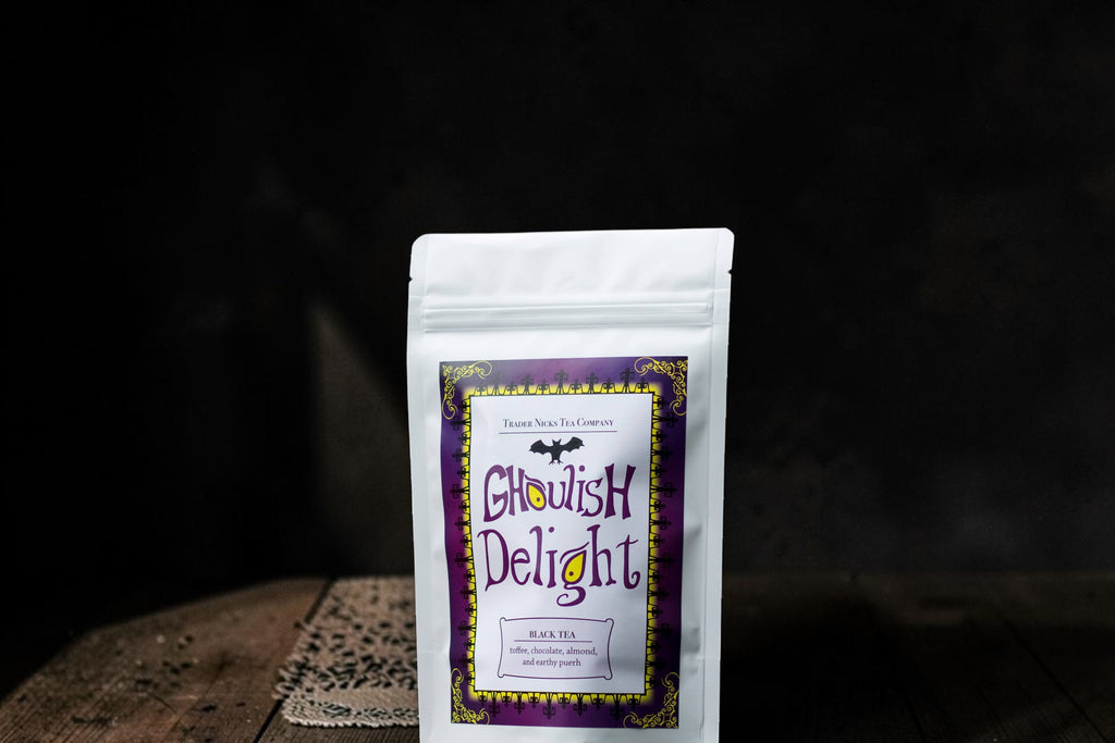 Halloween-Emporium Ghoulish Delight chocolate black tea in a white stand-up pouch with a purple gothic label.