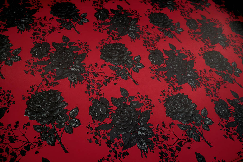 Halloween-Emporium matte gift wrapping paper featuring an intricate black rose pattern on a vibrant red background.