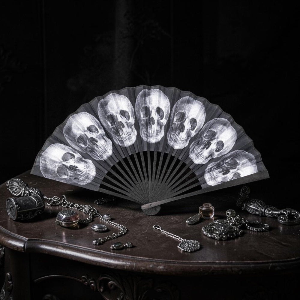 Halloween-Emporium gothic handheld folding fan featuring a monochromatic skull pattern on a black background.
