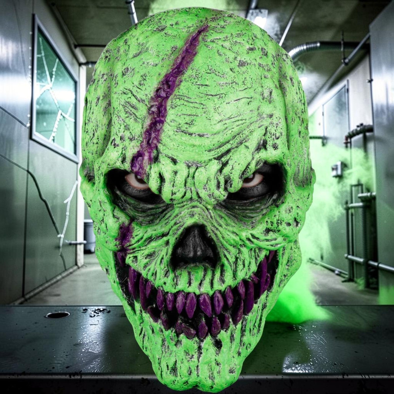 Halloween-Emporium neon green monster latex mask with purple fangs and textured skin in a spooky industrial setting.