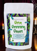Halloween-Emporium Grim Grinning Green spiced apple green tea in a white stand-up pouch with spooky ghost label art.