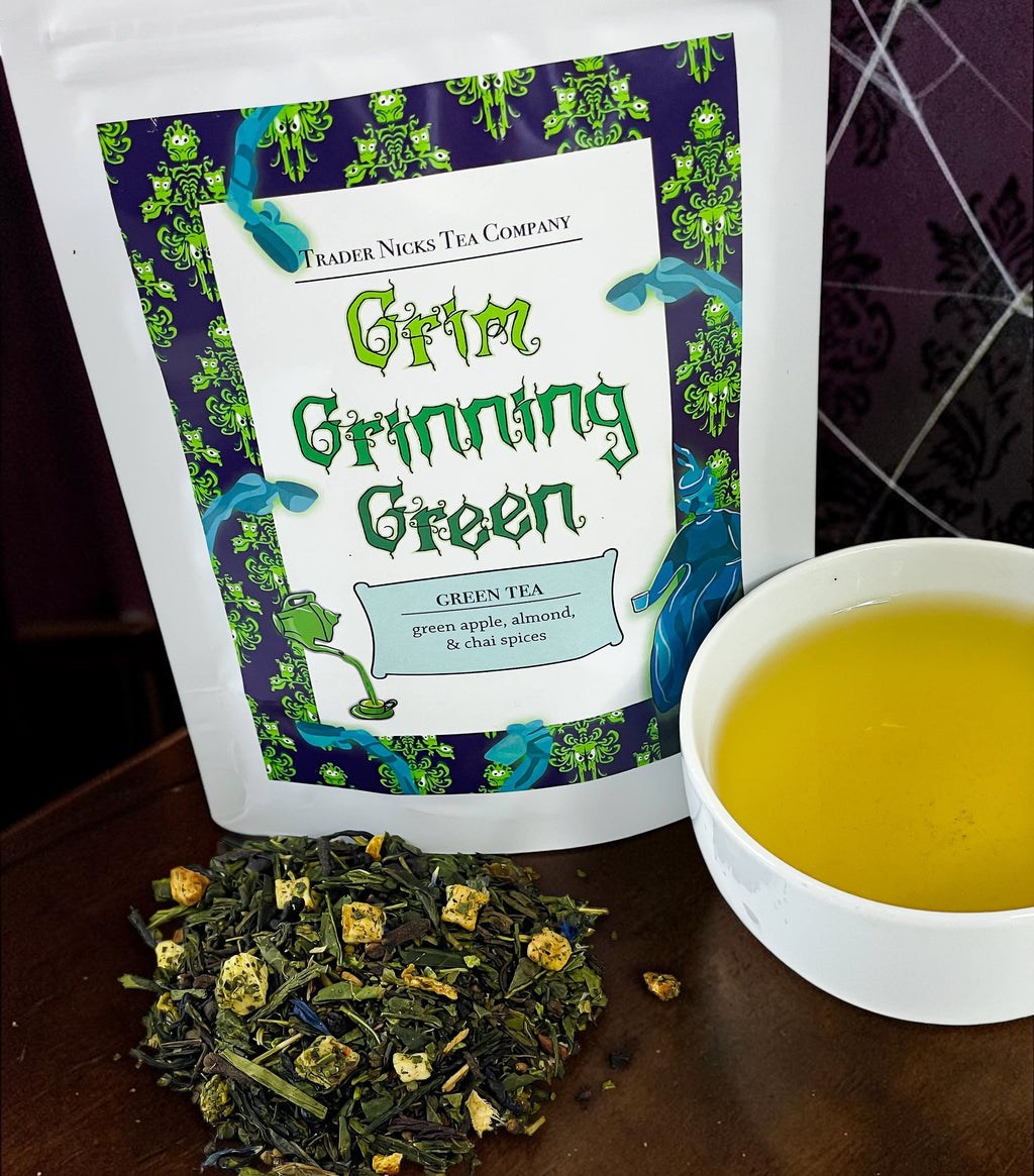 Halloween-Emporium Grim Grinning Green spiced apple green tea loose leaf blend with a cup of brewed tea