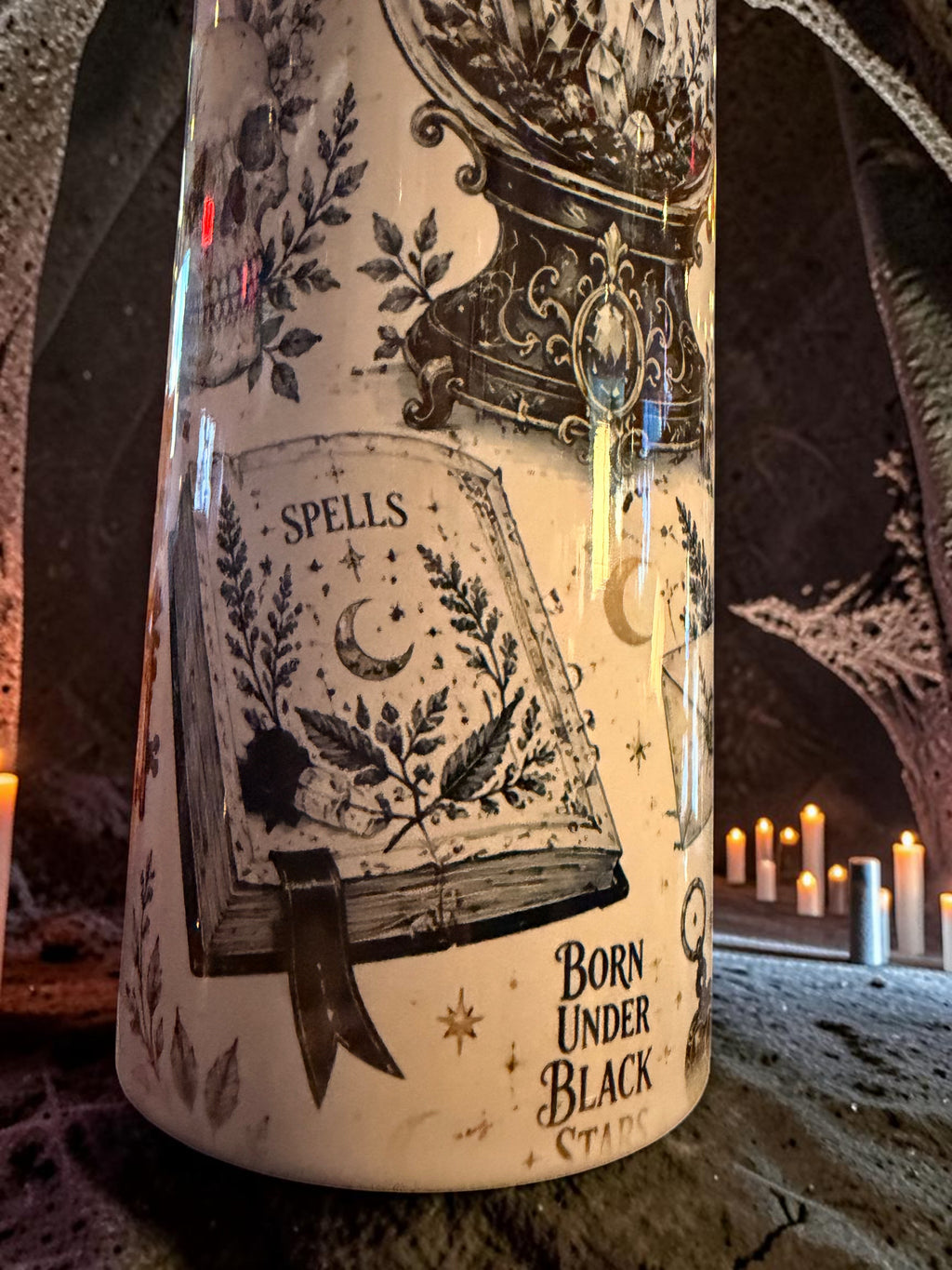 Halloween-Emporium 30oz tumbler featuring occult grimoire illustrations, spell book, and moon motifs in a dark setting